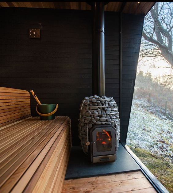 HUUM HIVE Wood 13 sauna stove installed in a sauna room