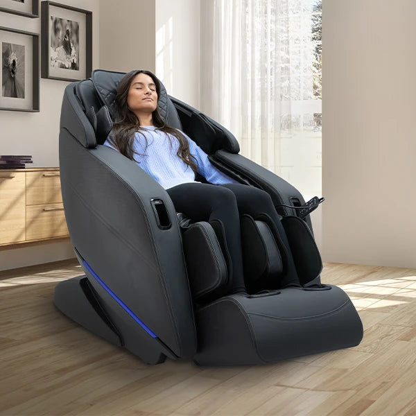 Kyota Yugana M780 black massage chair in zero gravity position with 4D massage rollers, SL-track system, full body air compression, and deep calf and foot massage in a modern living room