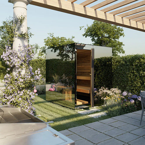 ThermaSol Vue mirrored glass outdoor sauna cabin installed in landscaped backyard with pergola and garden plants reflecting on glass exterior