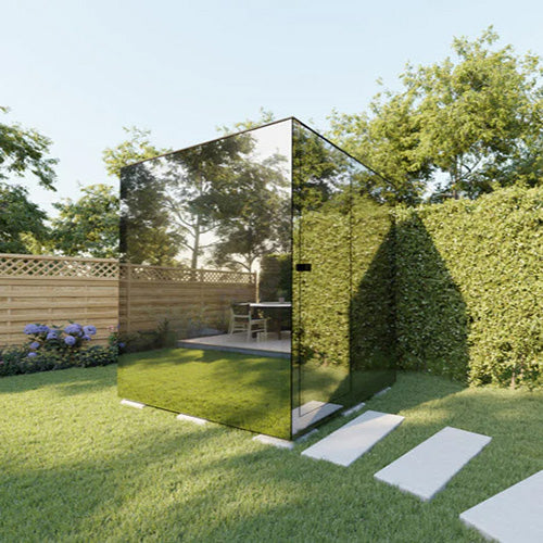 ThermaSol Vue outdoor sauna cabin with mirrored thermal glass panels installed in modern backyard garden setting with panoramic reflective design