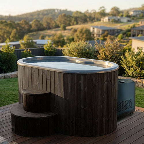 SaunaLife S2BC black cold plunge tub and chiller set up on an outdoor deck with a scenic view