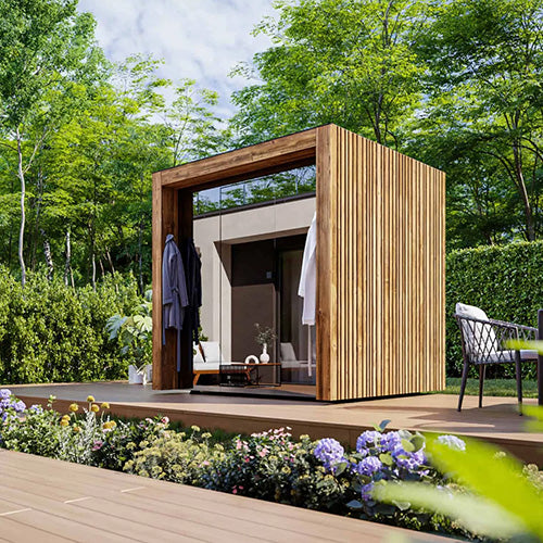 ThermaSol Fortis outdoor sauna cabin installed in modern backyard with wood exterior, tinted glass front, and contemporary luxury outdoor wellness design